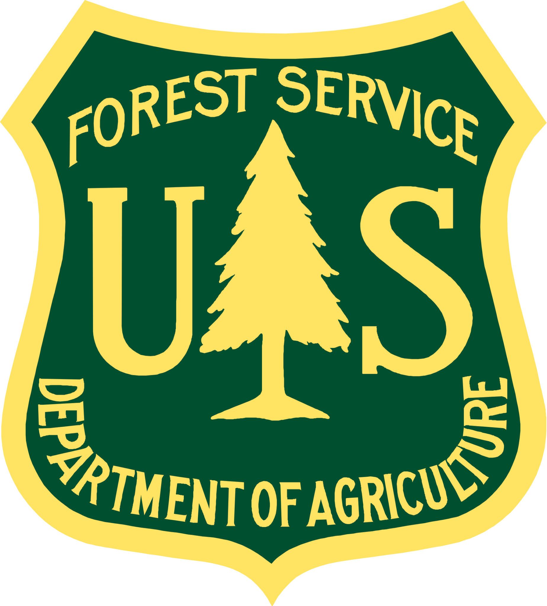 US Forest Service logo, a badge shape outlined in yellow with a dark green background and a yellow fir tree in the center. Text reads US Forest Service Department of Agriculture