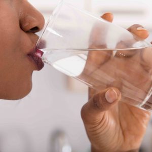 Close-up Of A Woman's Hand Drinking Glass Of Water