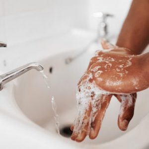 Cropped shot of an unrecognizable man washing his hands in the bathroom at home