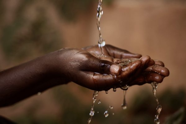 Social,Issues:,Water,Pouring,In,African,Child's,Hands