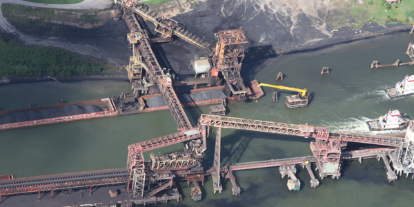 Figure 1. Petcoke and coal debris flowing from United Bulk Terminal, even when no loading/unloading was occurring. August 25, 2012. Photo: Healthy Gulf. Flight courtesy of Southwings.org.